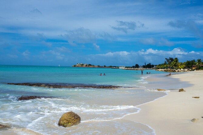 Famous Red Phone Booth Beach (Dickenson Bay) and Fort Bay Beach - What your first beach hour is really for